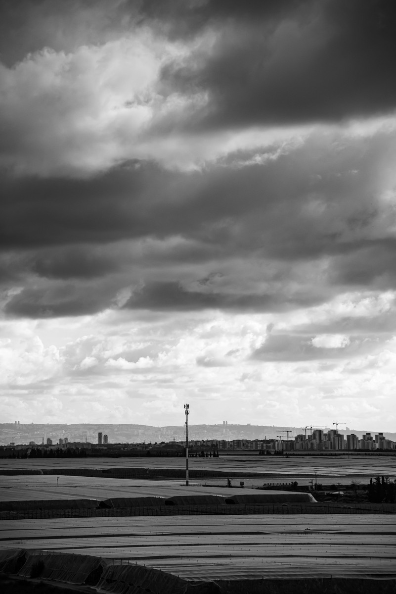 Dramatic black and white landscape of agricultural fields under stormy skies near Shlomi northern Israel
