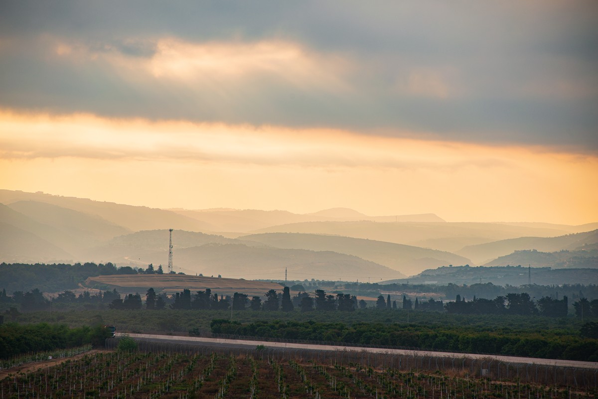 Golden hour sunrise over rolling hills and valleys of northern Israel near Shlomi with dramatic clouds